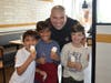 Jaxton Saccomonto, Arav and Satva Pathak enjoy cones with officer Creighton on the last day of school.