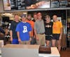 Coaches and team volunteers take one last picture before the FUNdraising is over for the night.