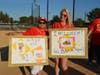 Griselda Sanchez, Bear Family McDonald's restaurant supervisor and Nicole Buchanan, Bear Family Director of Operations show off their posters for the Charity Softball game.