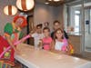 ​Eliana Gazzano, Valentina Gazzano, Massimo Nalbono, and Bella Bravec all get balloons at the Bloomingdale Grand Re-opening event with Strawberri the clown.