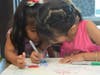 Sisters Camilla and Freida Roldan busy writing what they are grateful for at the Morton Grove McDonald's back to school event.