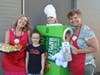 ​Madelyn McGinnis and teachers Cinnamon, Peterson, and Engstrom work the Drive-Thru selling pies to support Malta Elementary school.