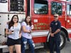 Firefighter and EMT John Kowalski showed students Fatima Munos and Erna Obic around one of the Fire Trucks and explained how it is used during a fire or rescue call.