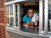 Mrs. Talley works the drive-thru window during McTeacher's Night at McDonald's in North Aurora