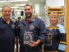 Northwest Chargers Hockey Association hockey director Tim Mueller, Coach Ray Pecora and Event Organizer Kimberly Dahlin work behind the counter during the McCoaches Night held on October 21st at the Mt. Prospect McDonald's
