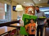 HC Storm Student Isabella Mathis was happy to take a picture with Mrs. Mann, dressed as an Apple pie, and Mr. Stanczak selling pies alongside her