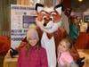 Kalee Stocker and Zoe Nigoza take a picture with Fox the school mascot during Fox Meadows McTeacher's night in South Elgin  