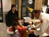 Fire Chief Marty Feld hands out the first slushies of the event, kickstarting the event Pictured is Grace Chan, with her children Megan and Amy Chan,