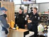 Deputy Police Chief Naydenoff serves coffee for a customer