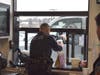 Officer Josh Jacobs helps serves orders at the drive-thru