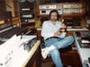 Bill Rock holds a Telly award at his home production studio in Stratford.