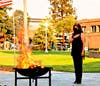 Foundational Builders Sr. Project Manager Diana Rangel Vierra watches on as Old Glory is consumed by the flames.