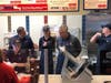 Gary Staub, Jersey Mike’s Area Director, gives 97.1 The Ticket morning show hosts Mike "Stoney" Stone and Heather Park d