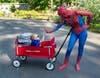 1-year-old Hudson Gray of Waterford high fives Spiderman ( Maya Rummel of Royal Oak) at Beaumont Children’s Walk for Miracles