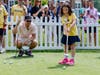 Mark Wahlberg watches as 2025 Corewell Health’s Children’s Miracle Network Ambassador Kennedy Shallal putts and challenges the actor to best her shot at the 2025 Feldman Automotive Children’s Miracle Celebrity Invitational.