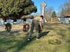Scout Austin Charise fastens the U.S. Merchant Marines ceremonial wreath. 