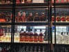 The Barrel Club's floor-to-ceiling rack of private label spirits.