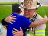 OLFD Fire Chief Mike Mavrogeorge hugs 6-year-old Vinny Ramirez whose quick thinking may have saved his neighbors' lives and their apartment building from going up in flames.