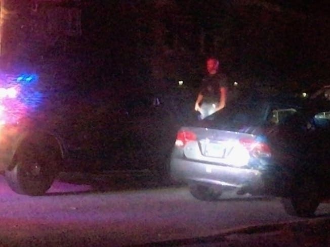 Evergreen Park police comb the 9100 block of South St. Louis St. where a man was shot to death on July 21. 