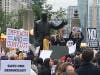 Demonstrators gather by the Irv Kupcinet statue in front of Trump Tower. 