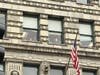 Office workers watch anti-Trump demonstrators march down Michigan Avenue. 