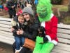 A mom and her child visit with Grinch at the 2018 Santa on the Green. 