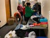St. Catherine students sorted and hung jackets on hangers.