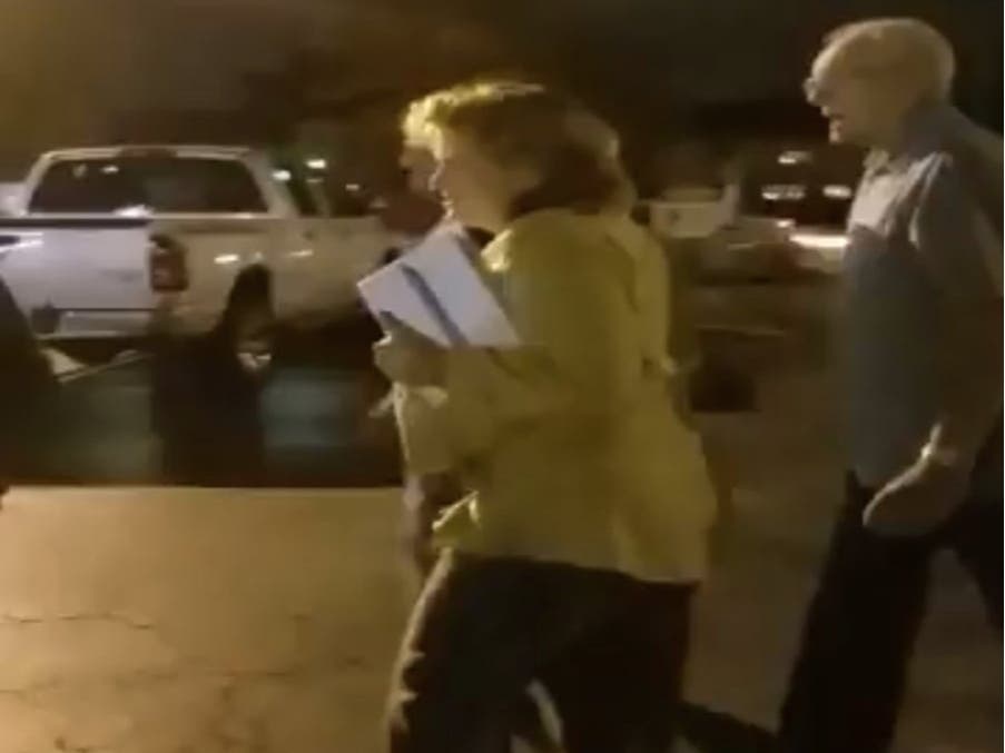 Tr. Sharon Brannigan tries to avoid protestors at a Palos Township board meeting in October 2017.