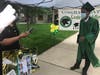 A graduate excepts his grammar school diploma at Central Middle School's drive-thru graduation. 