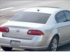 A Buick with temporary plates was captured by home security cameras.