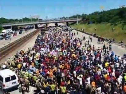 The Rev. Michael Pfleger leads protesters onto Dan Ryan Expressway in 2018.
