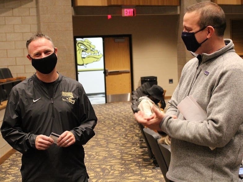 Richards High School teacher and coach Tony Sheehan accepts a $500 gift card after being recognized  by the IHSA in the "Teacher Spotlight" program. 