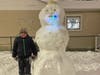 Vinny Carollo, 6, stands next to the giant snowman he built in Oak Lawn. 
