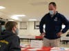 19th Ward Alderman Matt O’Shea admires the artwork of Mick O’Malley from the
St. Cajetan School Student Council.