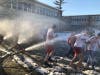 Marist High School athletes and students run through a polar cannon in the virtual Chicago Polar Plunge for Special Olympics Chicago/Special Children's Charities. 