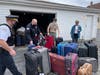 Chicago police officers load up donated luggage along with Evergreen Park boy scout Michael Klier and his mom, Georgette. 