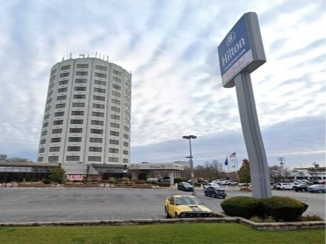 Two men are facing gun charges after shots were fired outside the Hilton Hotel in Oak Lawn.