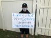 A boy holds up a sign paying tribute to Hometown police officer, Lt. James Kouski Jr., who died in the line of duty on April 3. 