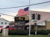 The American flag is lowered to half-mast in front of the Hometown Fire Department in honor of fallen Hometown police officer Lt. James Kouski Jr., who died in the line of duty on April 3.