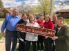 Joan Buschbach (middle in light jacket) along with her children and grandchildren at Wednesday's unveiling of an honorary street sign honoring her and her late husband Jim.