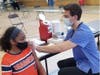 A student receives the Pfizer vaccine during a pop-up COVID-19 clinic at Stagg High School in Palos Hills.