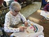 Arlene Concenti, a resident at Grace Point Place in Oak Lawn, adds her own artisitc touches to a kite for Southwest Chicago Christian School. 