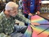 James Nottke, a resident of Grace Point Place Memory Care in Oak Lawn, makes a kite for students at Southwest Chicago Christian School.