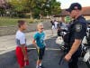 Youngsters chat with a Palos Hills police officer at National Night Out. 