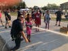 An Alsip firefighter assists a youngster in putting out a cardboard fire. 