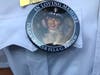 A Chicago police detective wears a button memorializing Officer Ella French. 