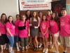 Renee Isadore's family stands with scholarship recipient Taylor Fugett on Pay it Forward Day