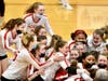 McAuley Liberal Arts High School's Mighty Macs celebrate their win over Willowbrook High School in the girls volleyball Class 4A supersectional. 