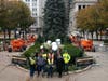 Electricians from M.T. Kelly gather in front of the Christmas Tree in Millennium Park after stringing it with 53,000 lights. 