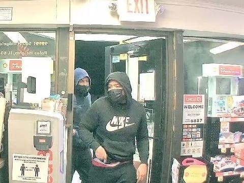 Palos Heights police released a surveillance photo of two men wanted in armed robbery of gas station. 